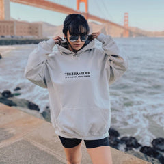 a woman wearing a sweatshirt with the golden gate bridge in the background
