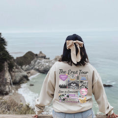 a woman with a bow on her head looking at the ocean