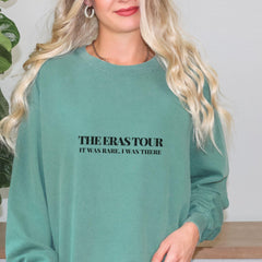 a woman with blonde hair wearing a green sweatshirt