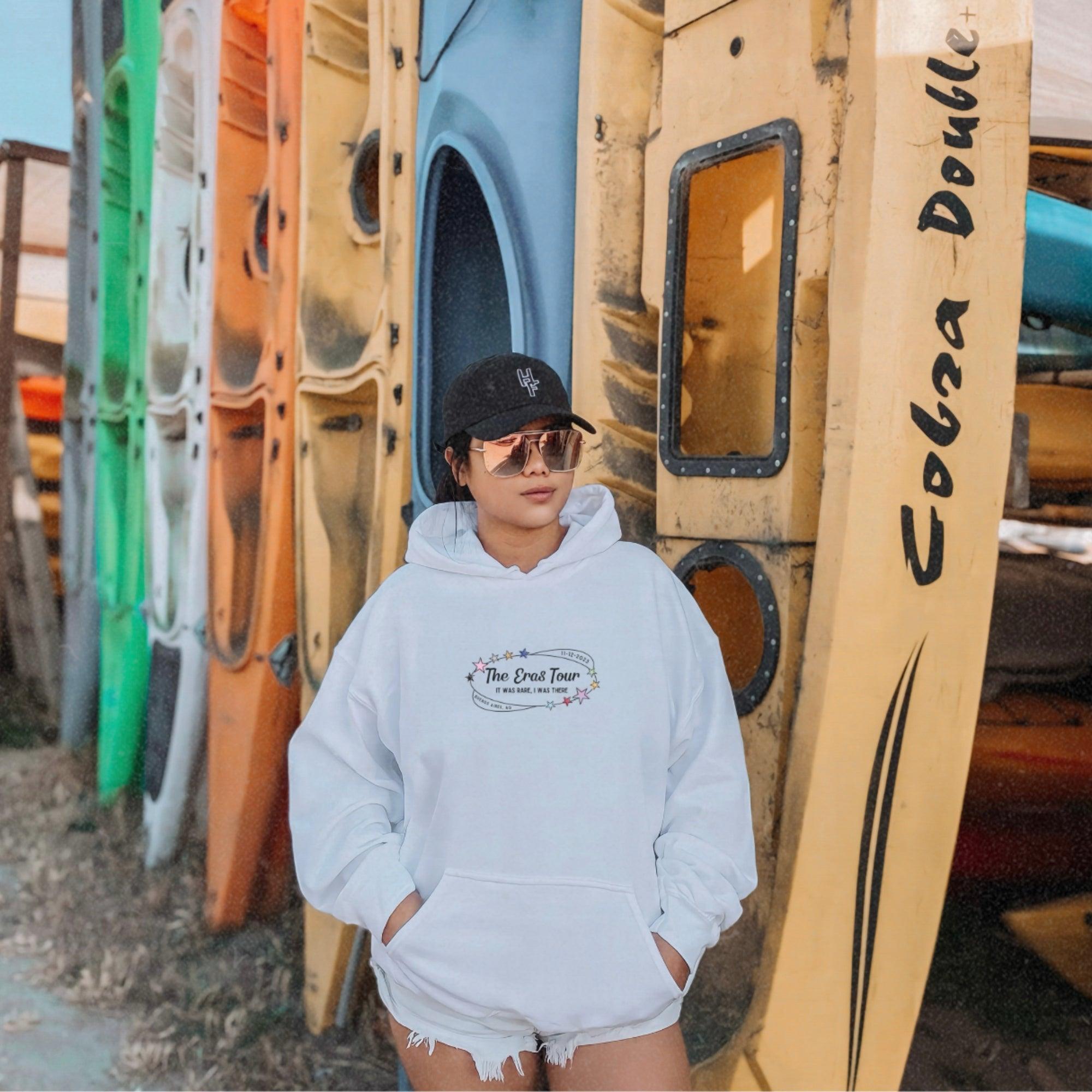 a person standing in front of a row of surfboards