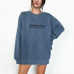a woman wearing a blue sweatshirt with the words the restator on it