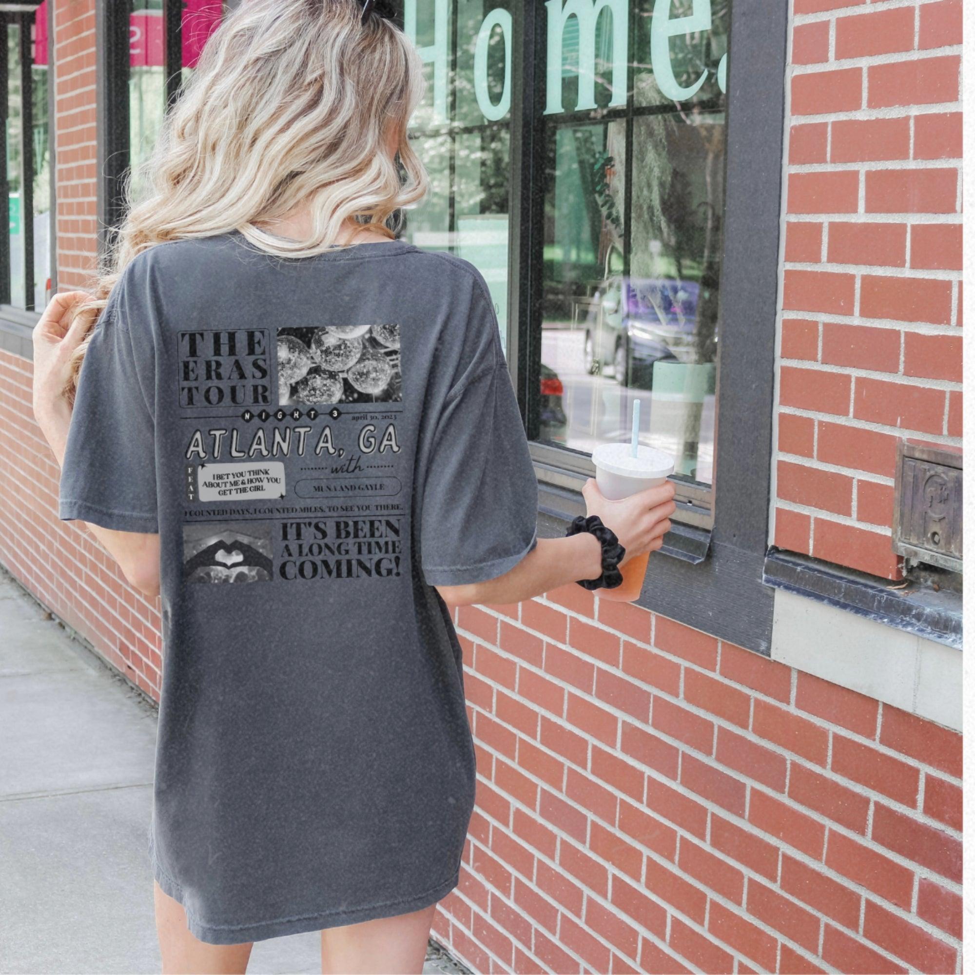a woman standing outside of a store holding a cup of coffee