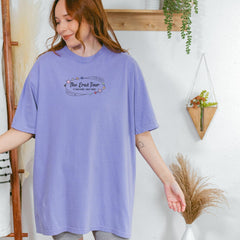 a woman standing in front of a white wall