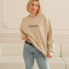 a woman standing in front of a white couch