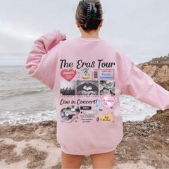 a woman in a pink sweatshirt looking out at the ocean