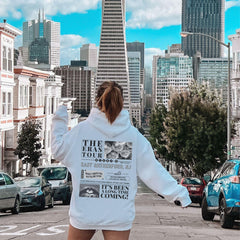 a woman riding a skateboard down a city street