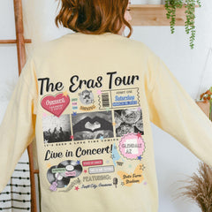 a woman wearing a yellow shirt with pictures on it