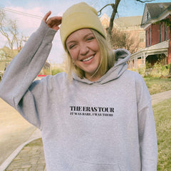 a woman in a grey sweatshirt and a yellow hat