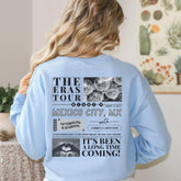 a woman wearing a light blue sweatshirt with the words the eras tour mexico city,