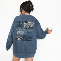 a woman standing against a wall holding a can of paint