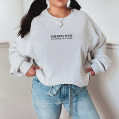 a woman wearing a grey sweatshirt with the words the bassfor on it