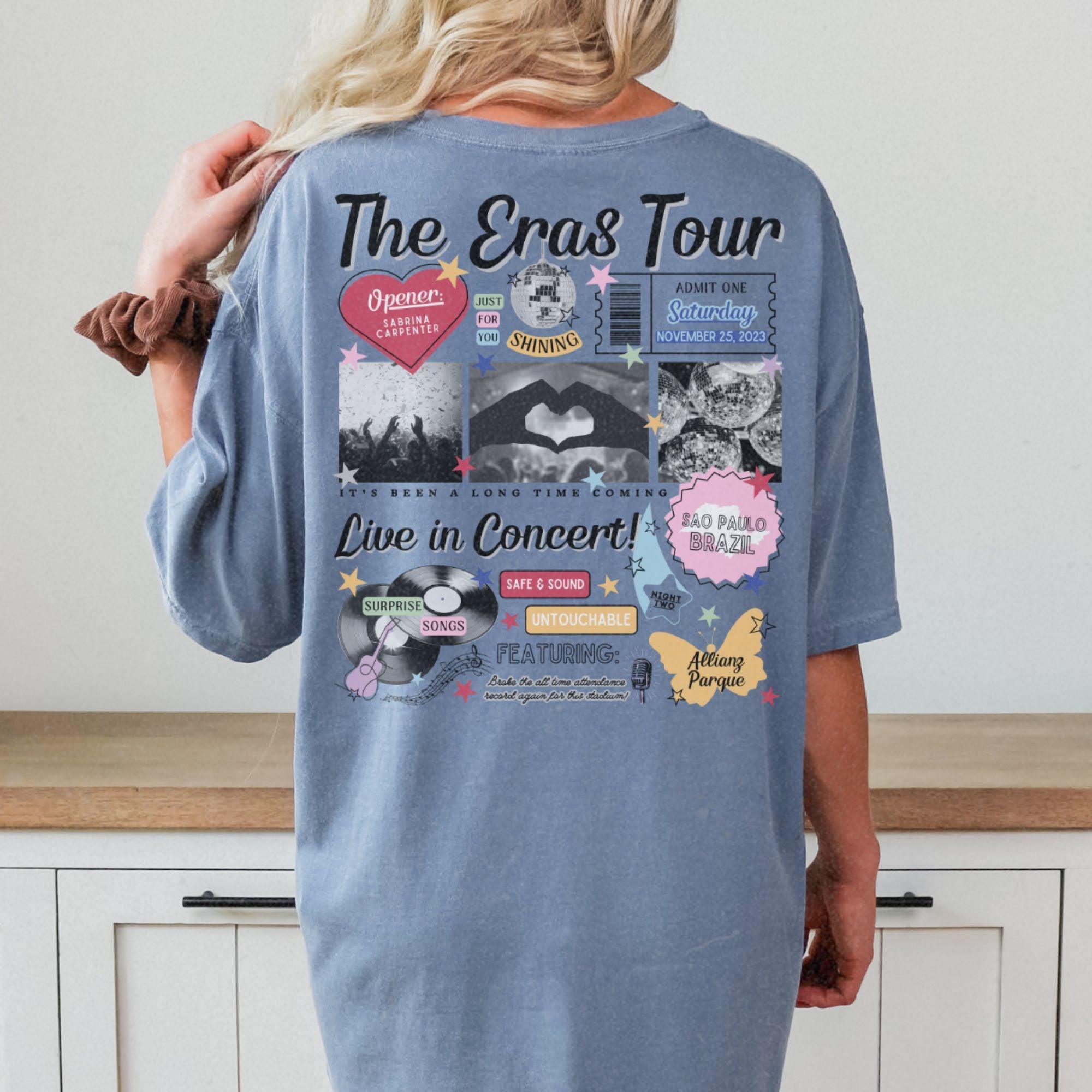 a woman standing in front of a counter wearing a blue shirt