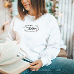 a woman sitting on a bench reading a book
