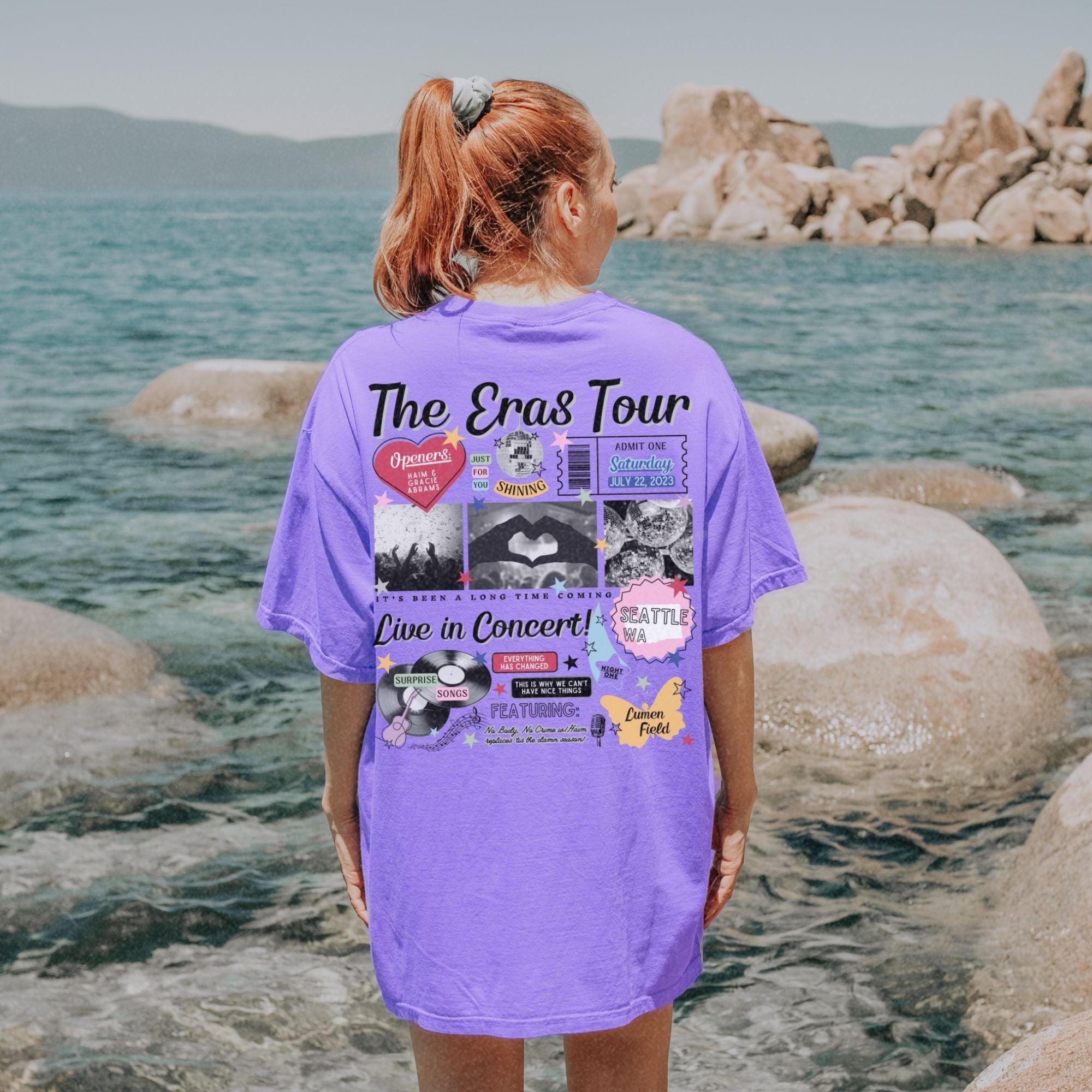a woman in a purple shirt looking out at the water