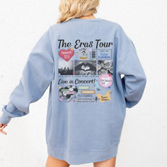 a woman wearing a blue sweatshirt with the words the grass tour on it