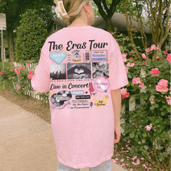 a woman in a pink shirt standing on a sidewalk