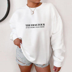a woman wearing a white sweatshirt with the words the erasour printed on it