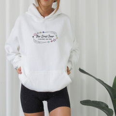 a woman wearing a white hoodie with the words the great tour on it