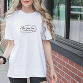 a woman in a white shirt is walking down the street