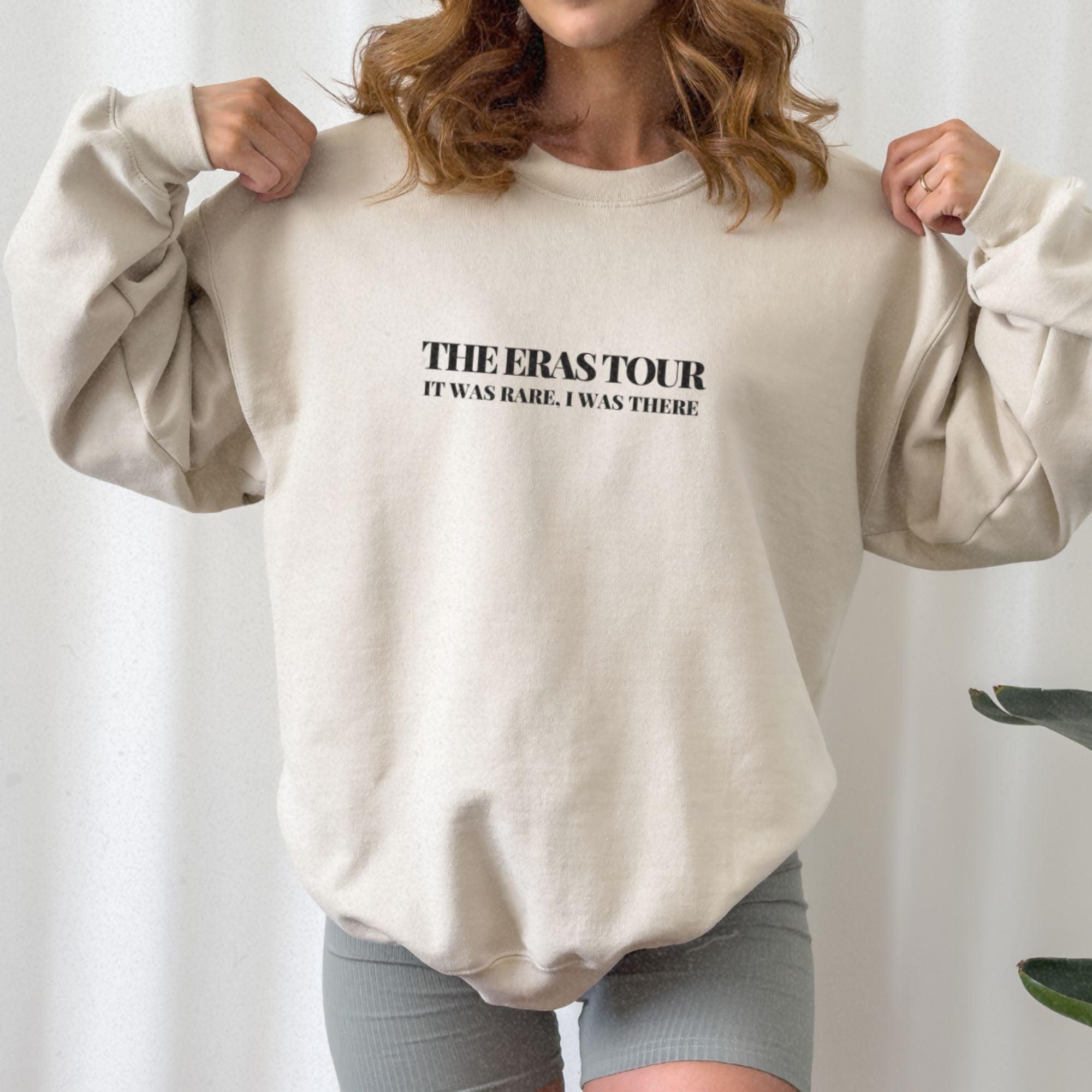 a woman wearing a sweatshirt and shorts