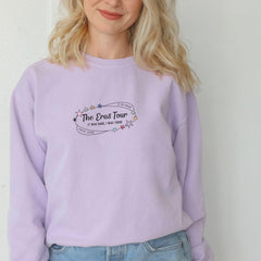 a blonde woman wearing a purple sweatshirt and jeans
