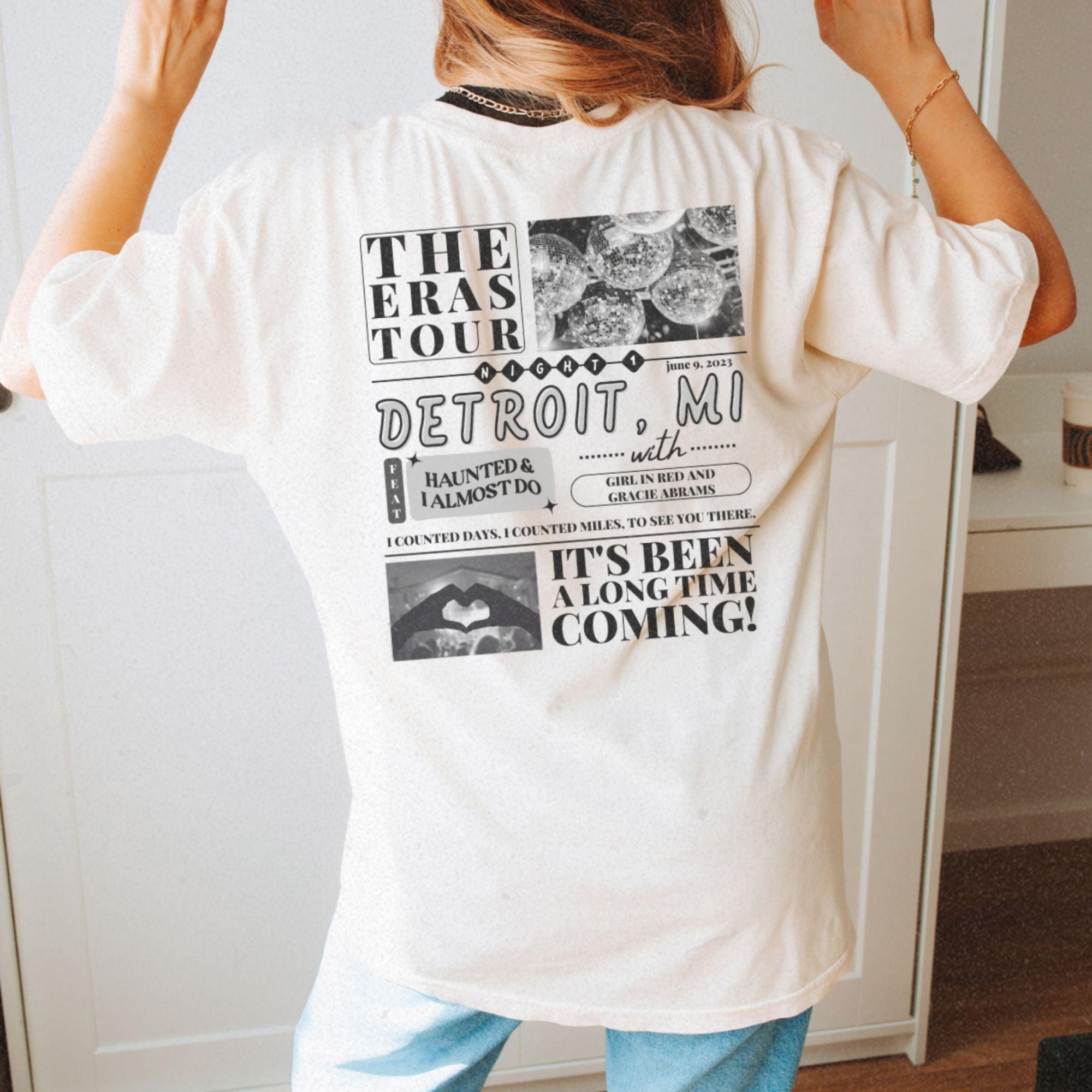 a woman standing in front of a mirror wearing a white shirt