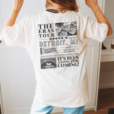 a woman standing in front of a mirror wearing a white shirt