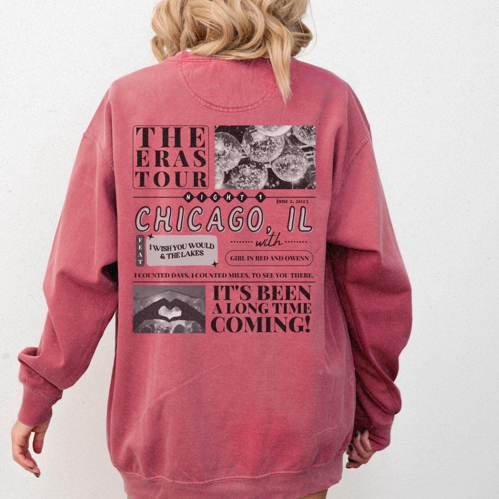 a woman wearing a pink sweatshirt with chicago images on it