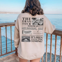 a woman standing on a balcony looking at the ocean