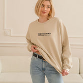 a woman standing in front of a white couch