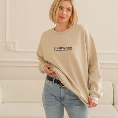 a woman standing in front of a white couch