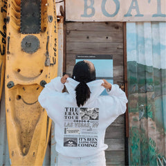 a woman standing in front of a yellow boat
