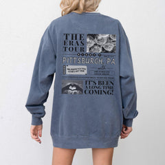 the back of a woman's blue sweatshirt jacket