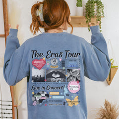a woman wearing a blue sweatshirt with the words the eras tour on it