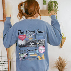 a woman wearing a blue sweatshirt with pictures on it