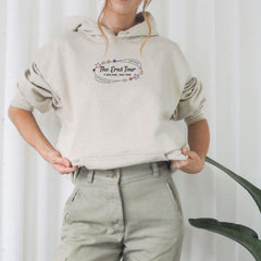 a woman wearing a hoodie with the words the great tour on it