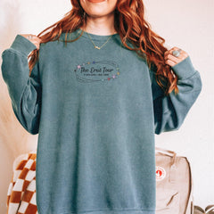 a woman with red hair wearing a blue sweatshirt