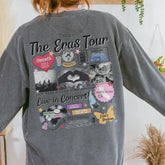 a woman wearing a gray sweatshirt with the words the eras tour on it
