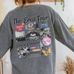 a woman wearing a gray sweatshirt with the words the eras tour on it