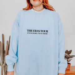 a woman with red hair wearing a blue sweatshirt