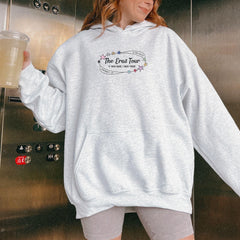 a woman standing in front of a refrigerator holding a drink