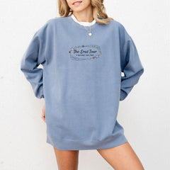 a woman wearing a blue sweatshirt with the words the end fair on it