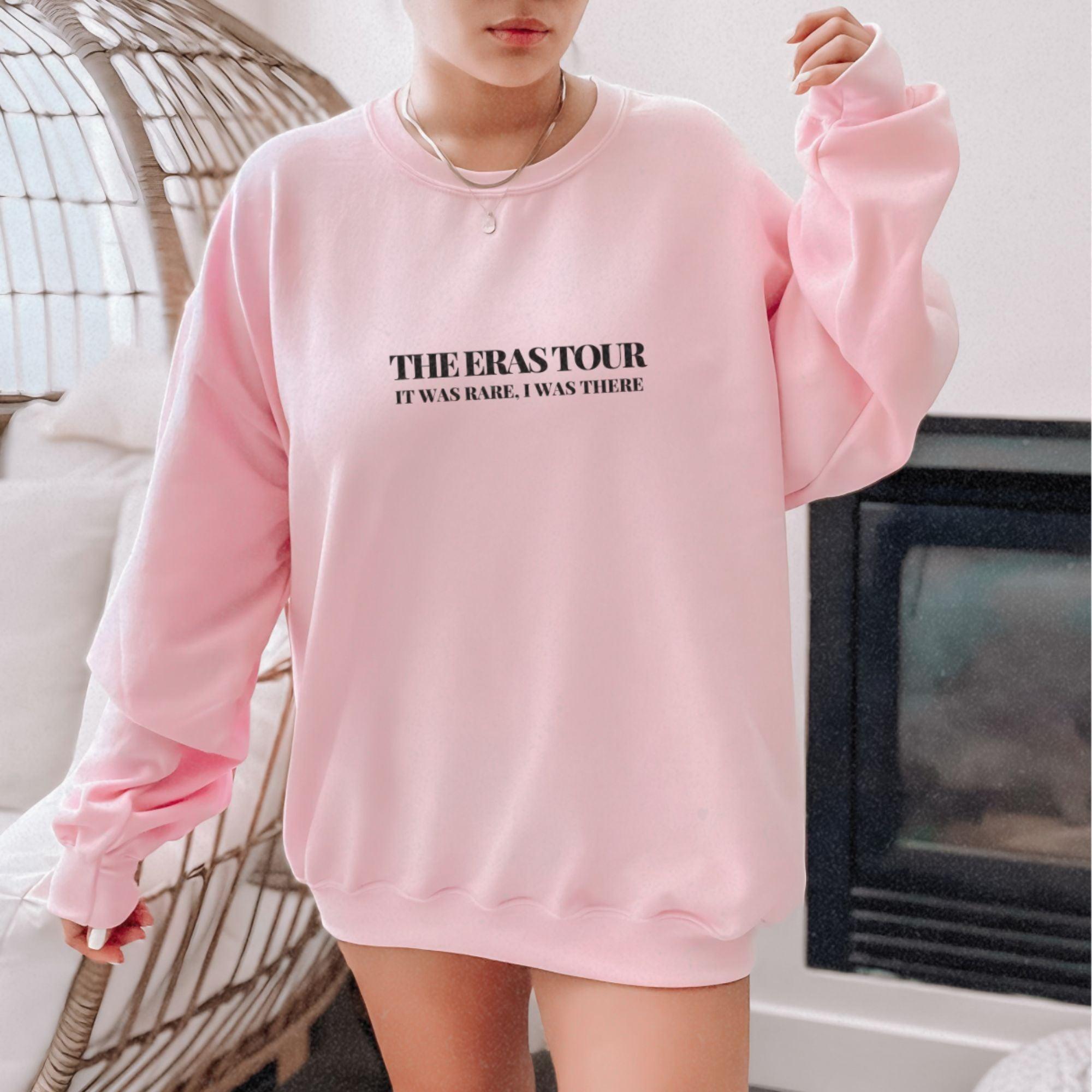 a woman wearing a pink sweatshirt and shorts