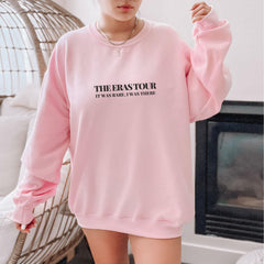 a woman wearing a pink sweatshirt and shorts