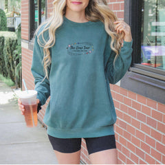 a woman standing outside of a building holding a drink