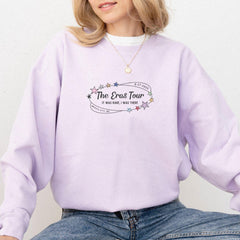 a woman wearing a purple sweatshirt with the words the bros tour on it