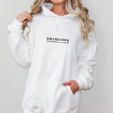 a woman wearing a white hoodie with the words therass tour printed on
