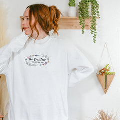 a woman with red hair wearing a white sweatshirt