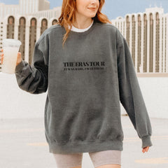 a woman walking down a street holding a drink