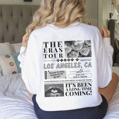 a woman sitting on a bed with her back to the camera